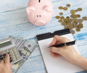 Saving Money with cash and coins with piggy bank and notepad